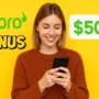 eToro $500 bonus promo with woman using smartphone on yellow background