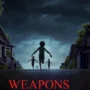 Kids running into the night in a mysterious suburban scene from Weapons 2025