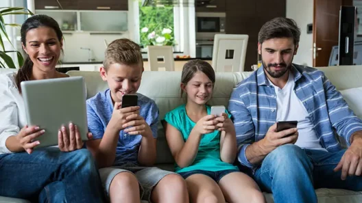 Family using multiple devices on the same home Wi‑Fi network, highlighting shared online privacy risks.