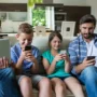 Family using multiple devices on the same home Wi‑Fi network, highlighting shared online privacy risks.