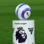 Premier League official match ball displayed on a pedestal with the Premier League logo during a live football match setup