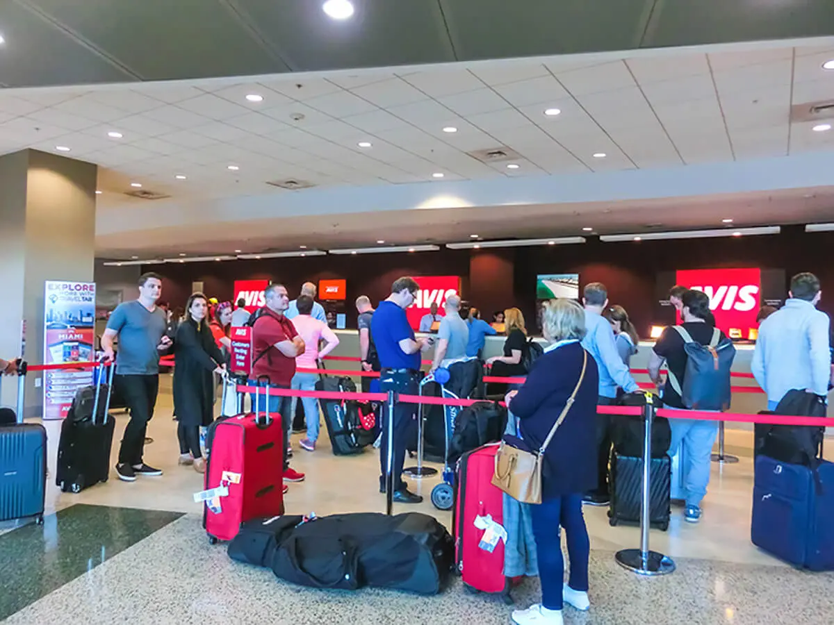 Queue at the Avis car rental desk at Heathrow Airport terminal