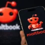 Close-up of the Moltbook logo on a smartphone screen, symbolizing the AI-only social platform at the center of a major 2026 security breach involving over 770,000 agent accounts